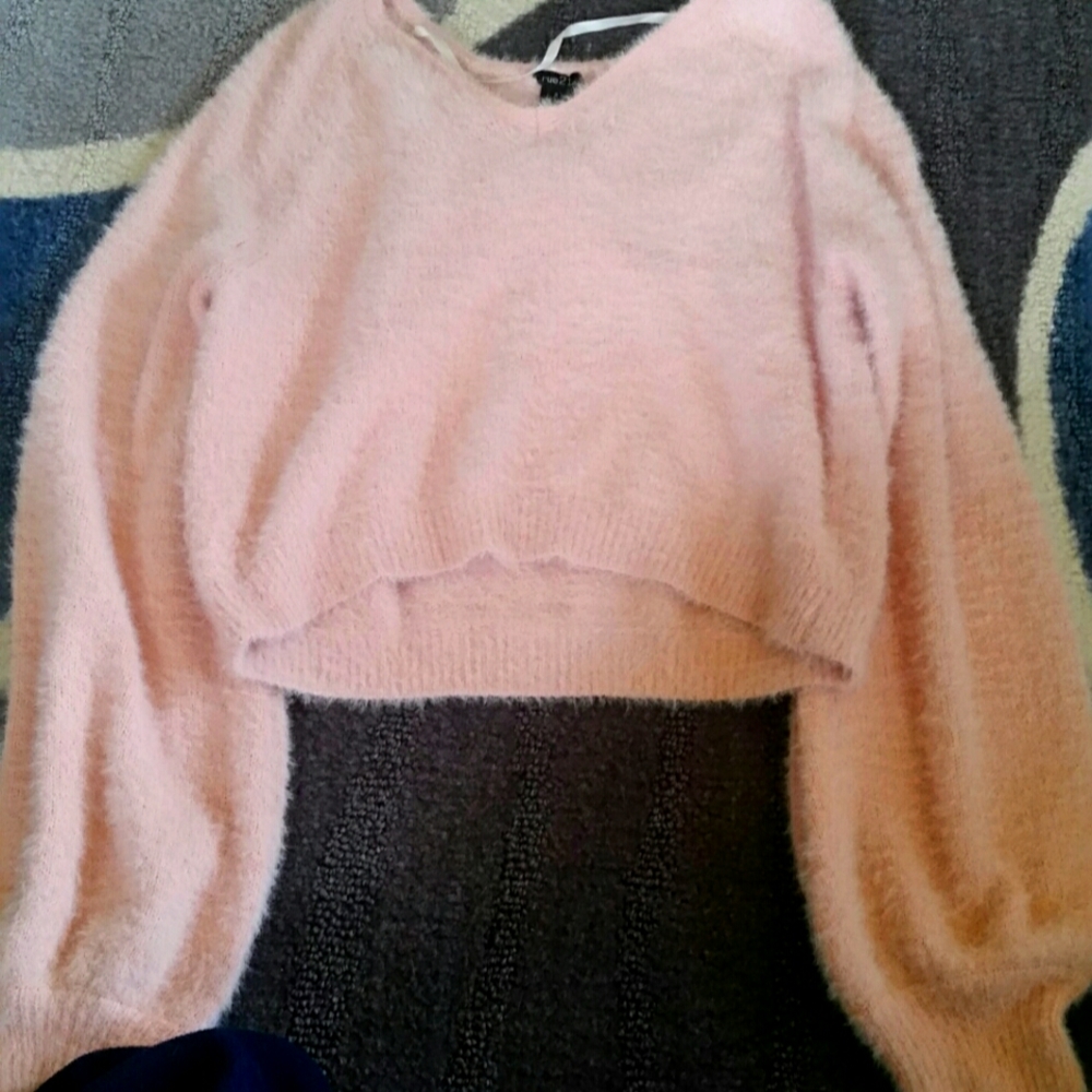 A pink fluffy crop top sweater
